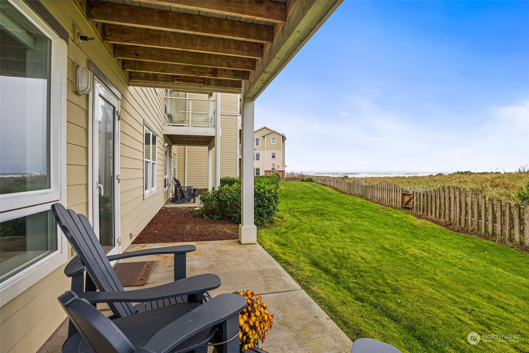 a view of an outdoor kitchen and seating area