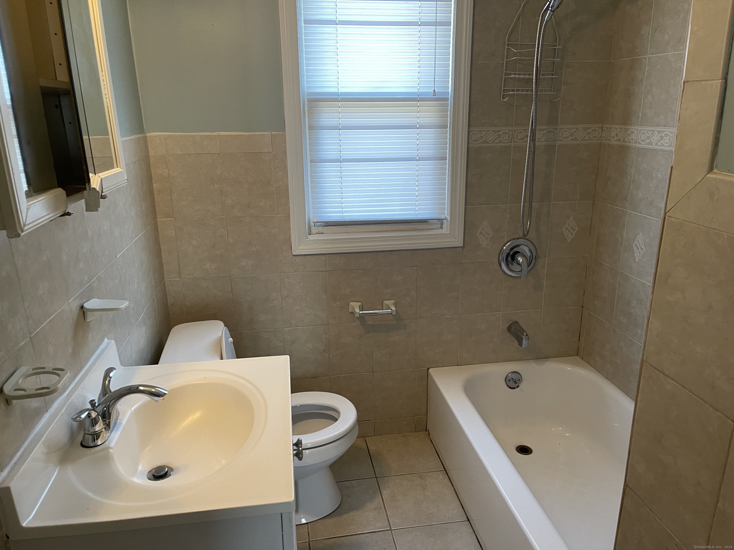 a bathroom with a sink a toilet and bathtub