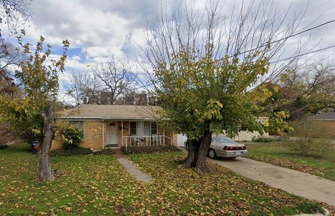 a view of a house with a tree in the yard