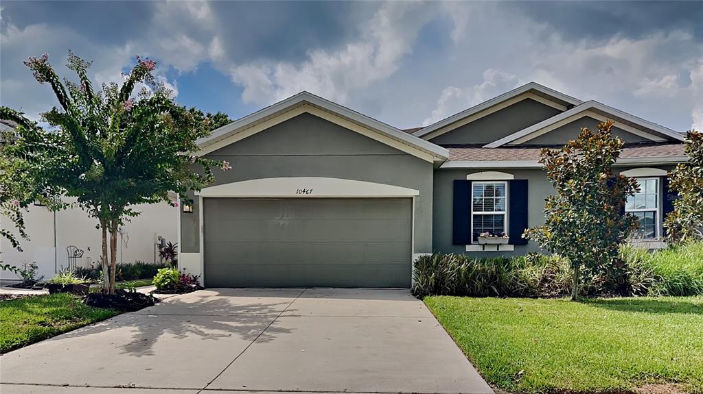 a front view of a house with a yard and garage