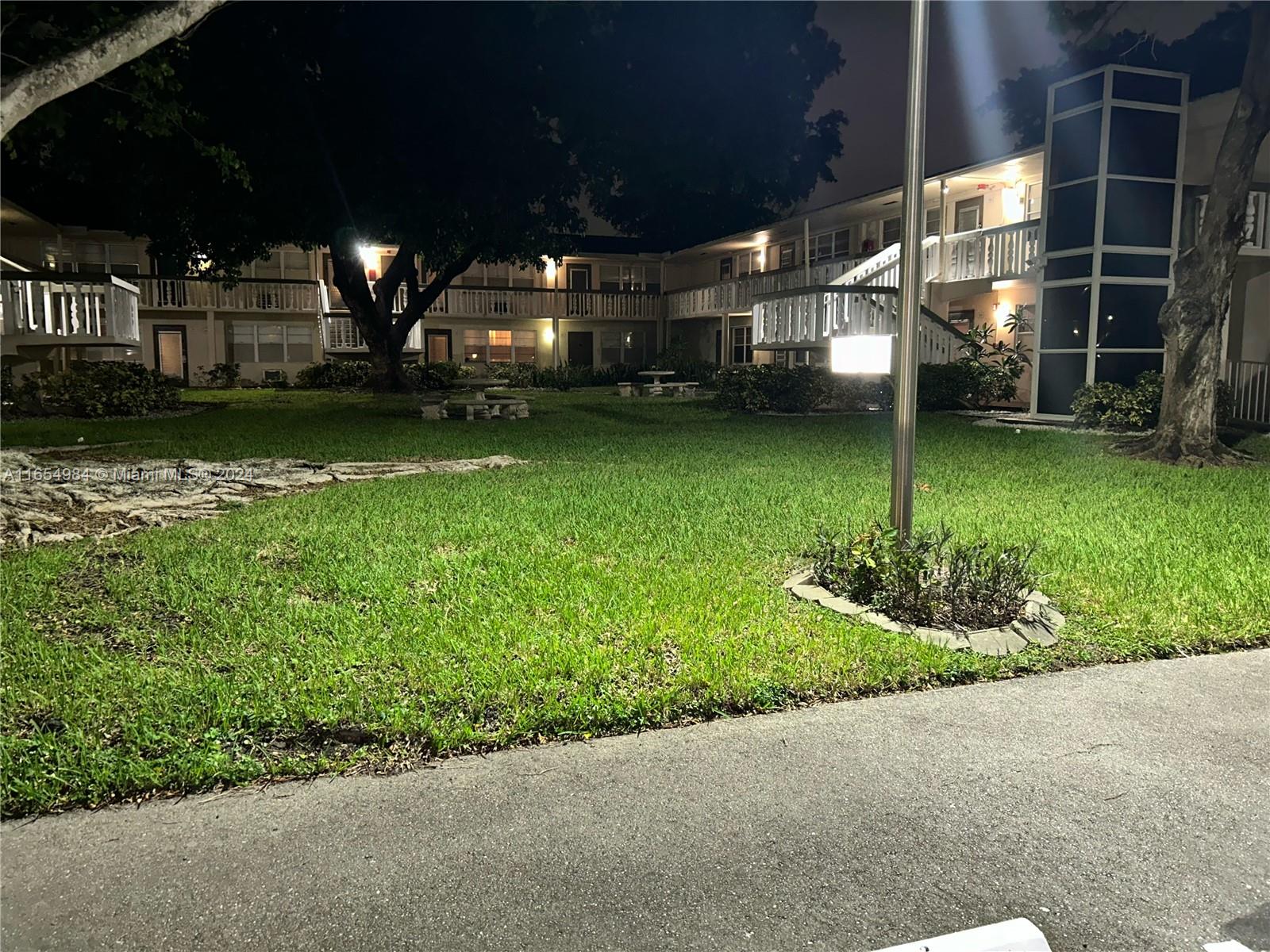 a view of a backyard with pathway