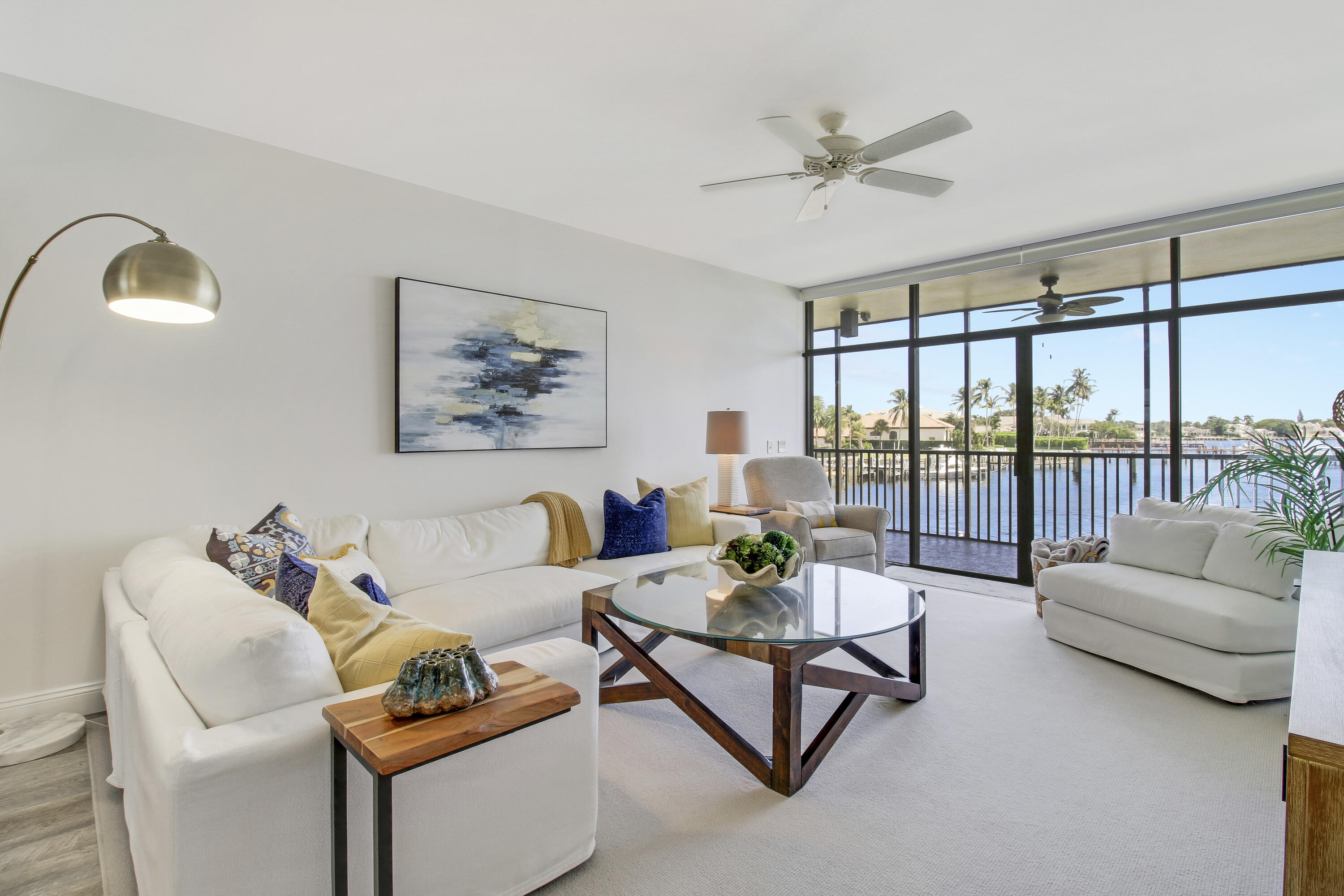 a living room with furniture and a large window with balcony view