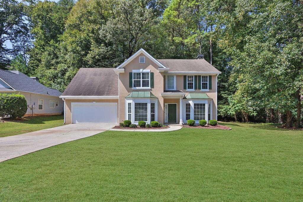 a front view of a house with a yard