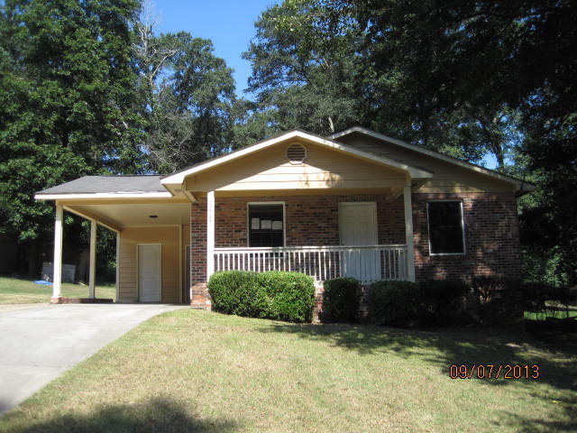 a front view of a house with a yard and porch