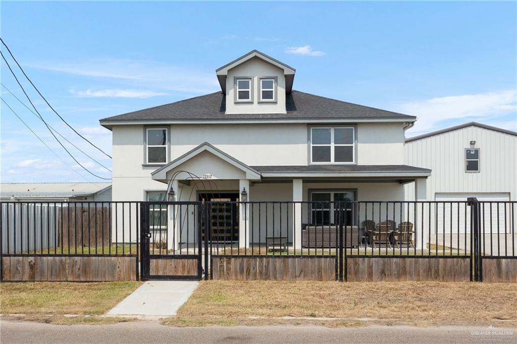 a view of a house with a small yard and wooden floor and fence