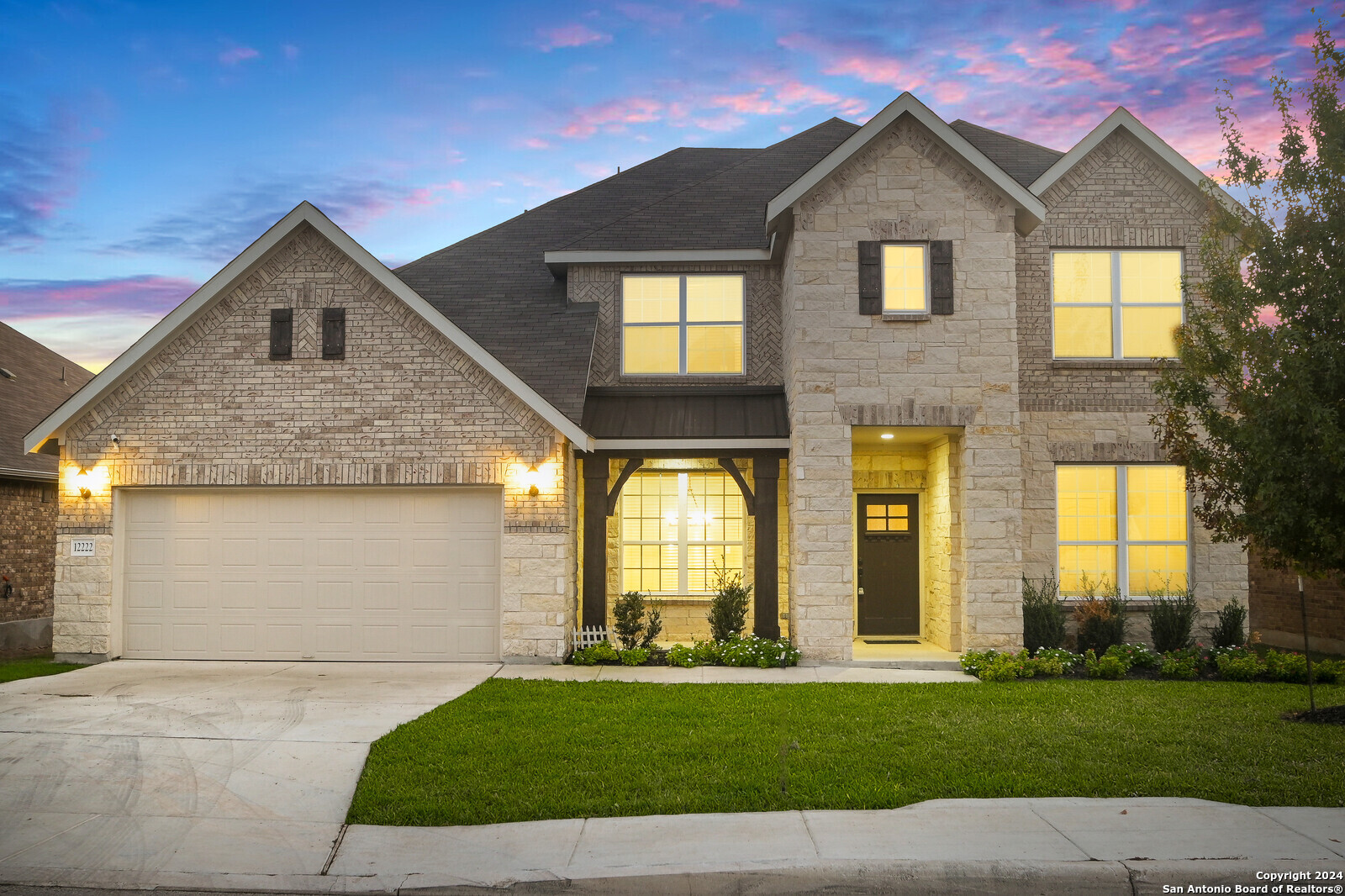 a front view of a house with a yard