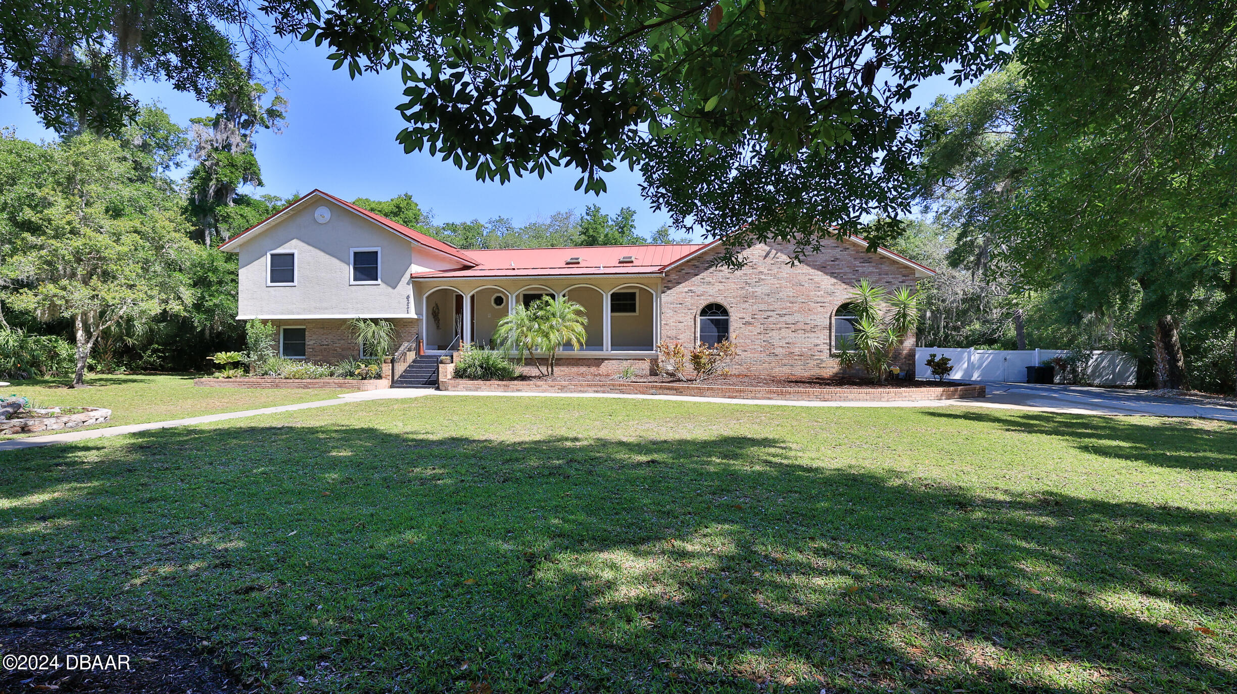 a front view of house with yard and swimming pool