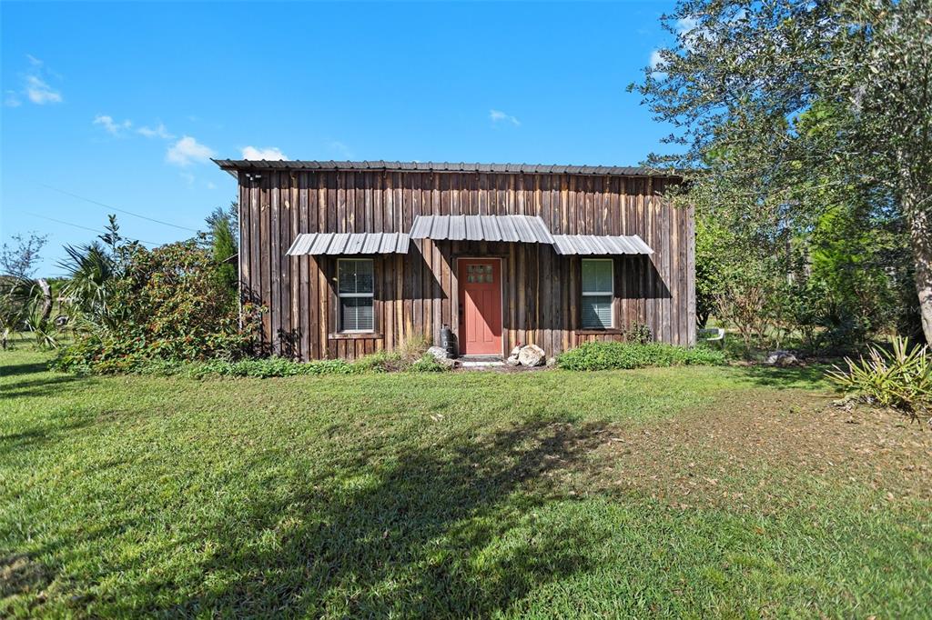 a view of a house with backyard and porch