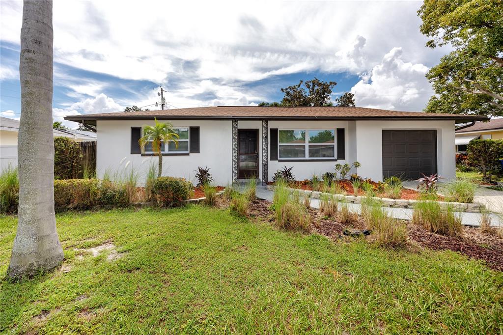 a front view of house with yard and seating space