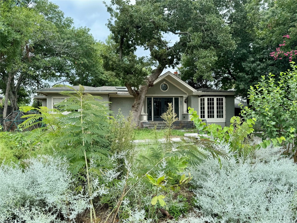 a front view of a house with garden