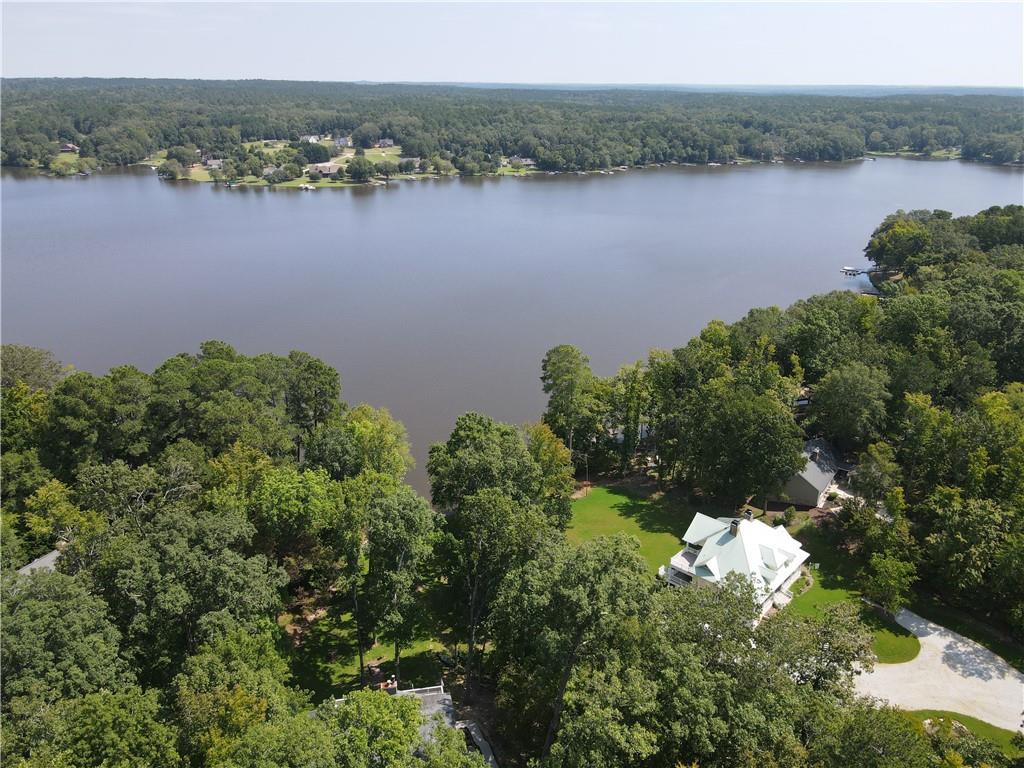 an aerial view of a houses with outdoor space and lake view