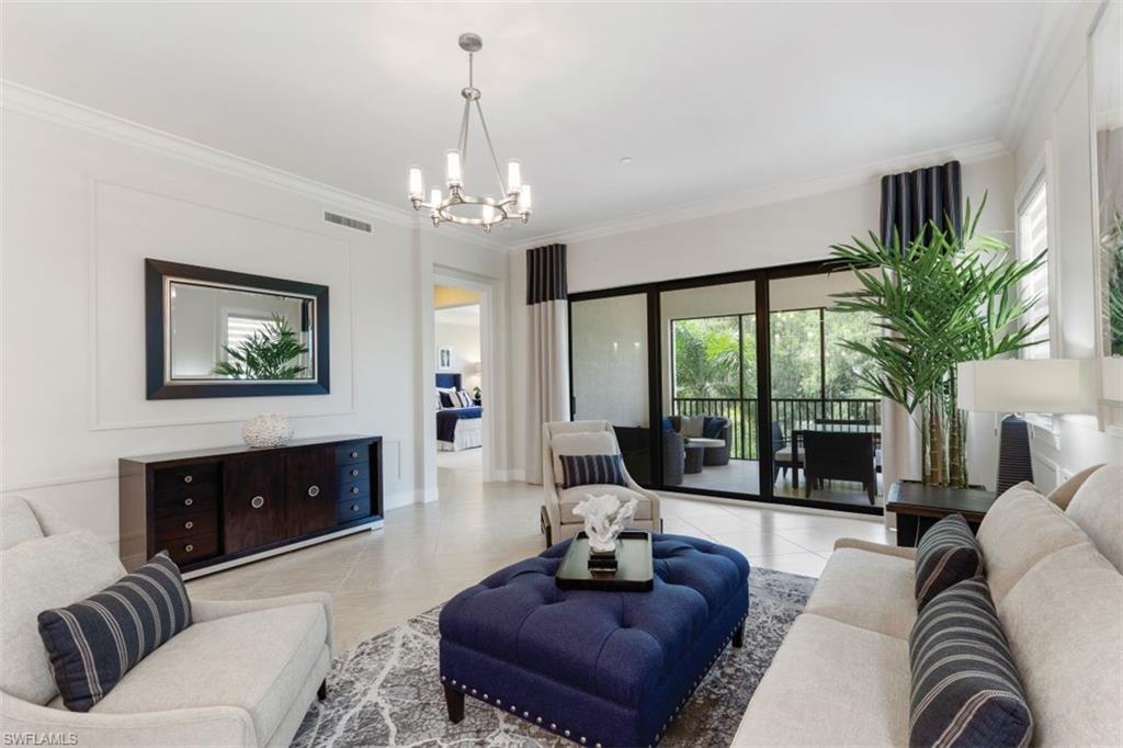 a living room with furniture a chandelier and a fireplace