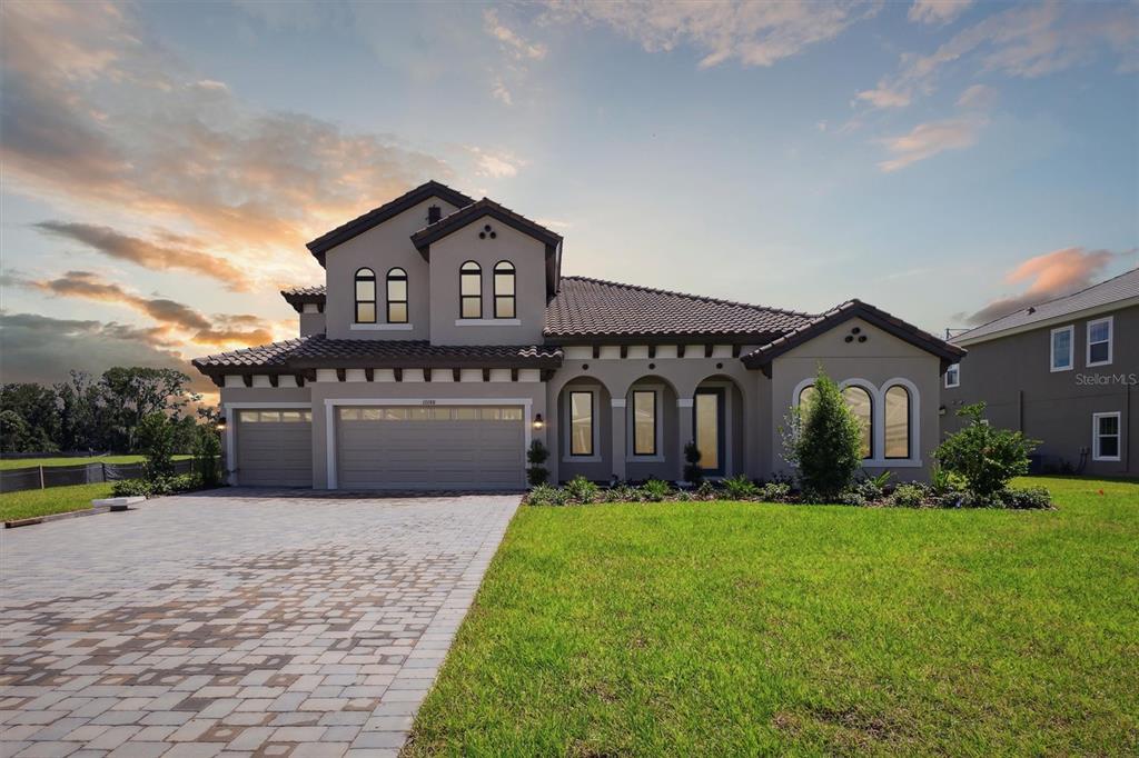 a front view of a house with a yard and garage