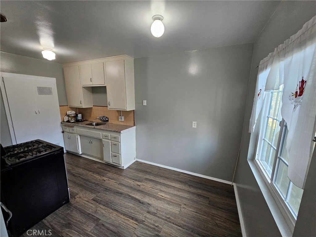 a kitchen with granite countertop a stove and a refrigerator