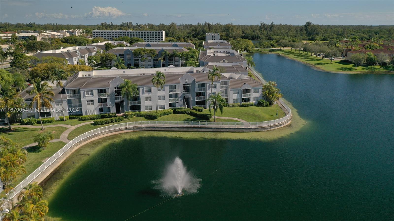 an aerial view of residential houses with outdoor space and lake view