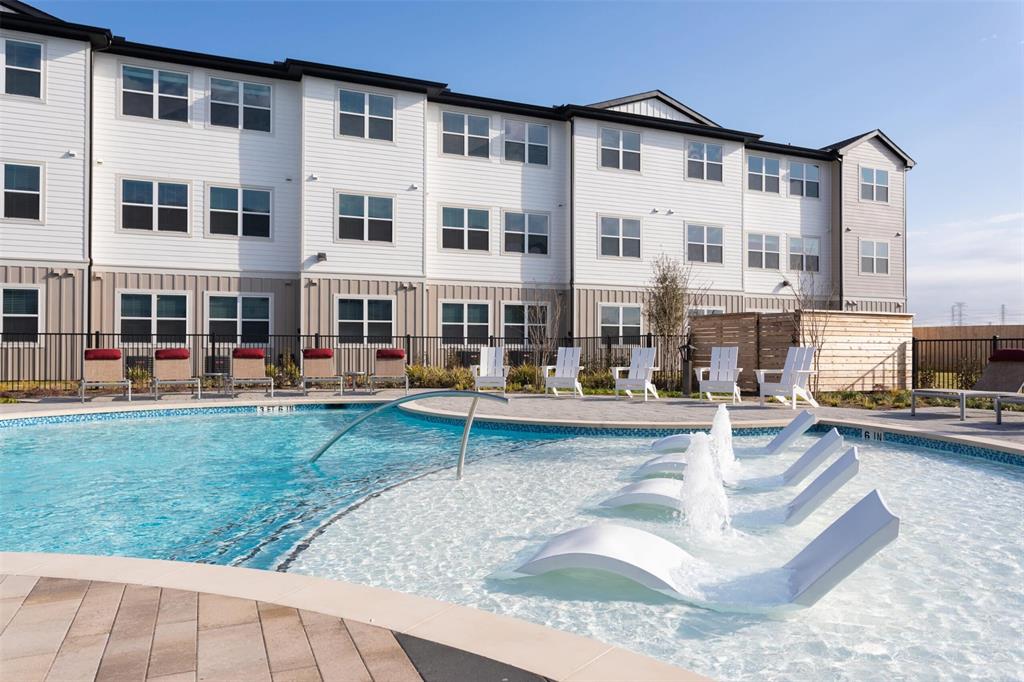 a view of a house with swimming pool and sitting area