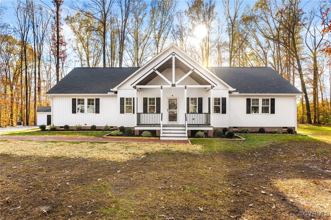 Modern farmhouse style home featuring a front yard