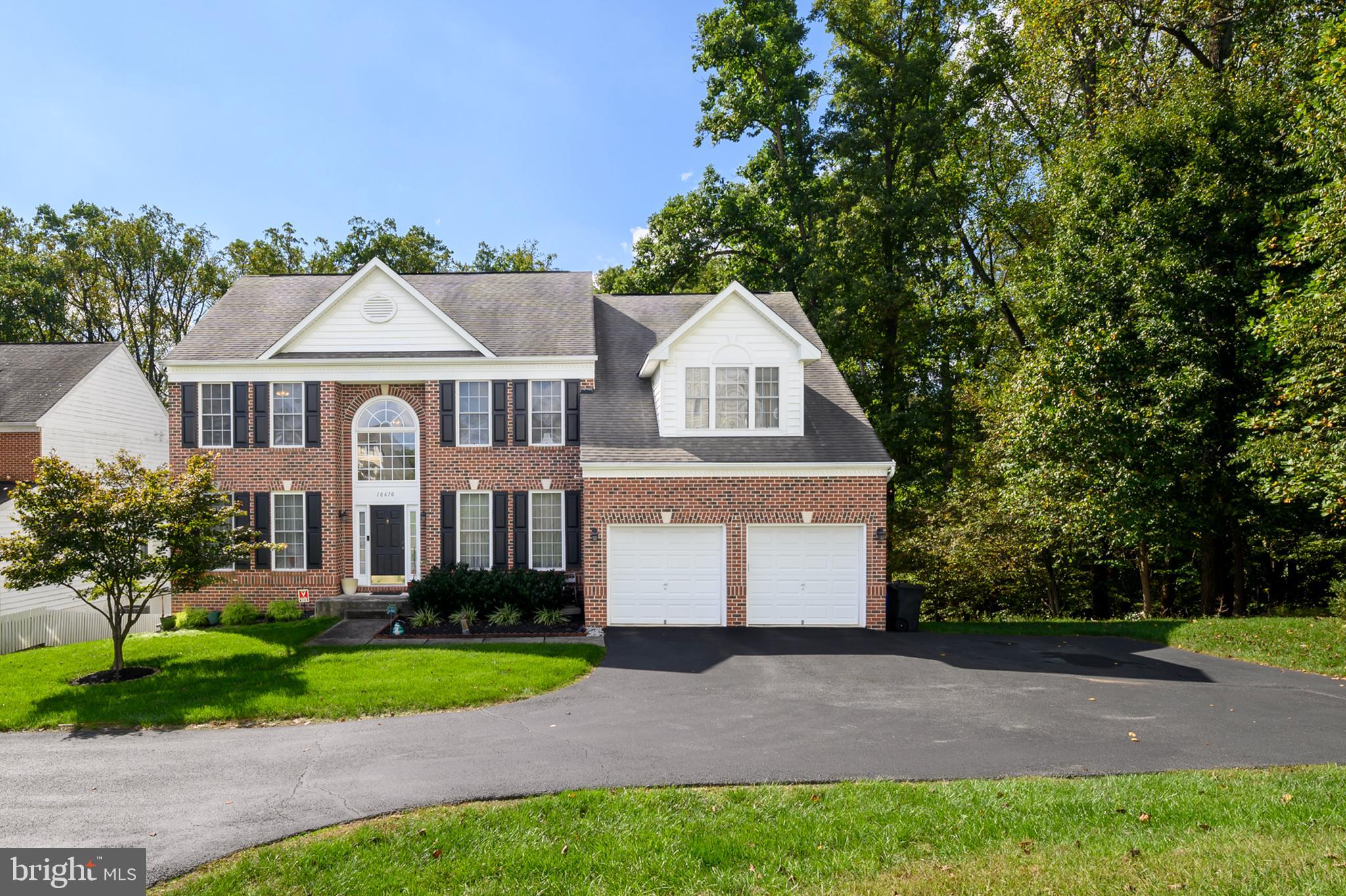 a front view of a house with a yard and a garage