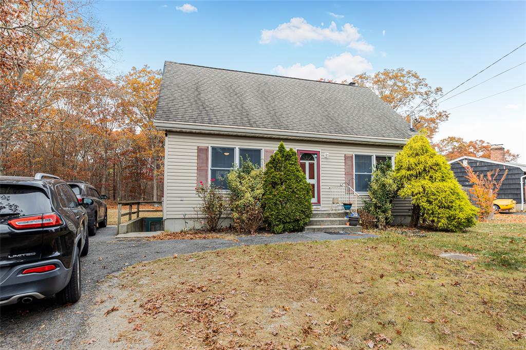 View of front facade with an outbuilding and a front yard