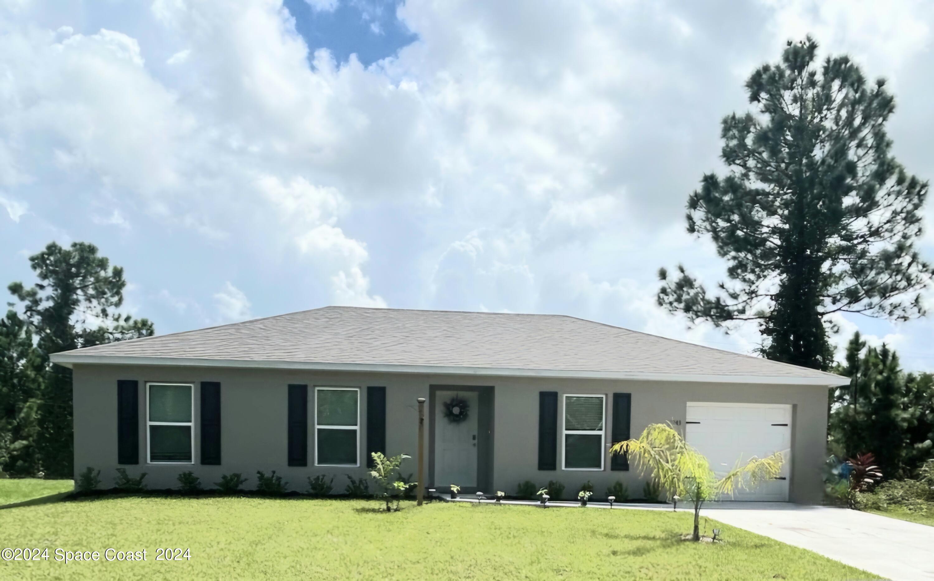 a front view of a house with a yard