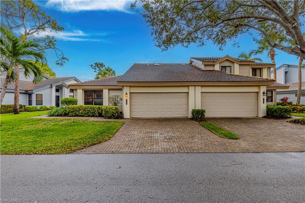 View of front of house featuring a garage and a front lawn