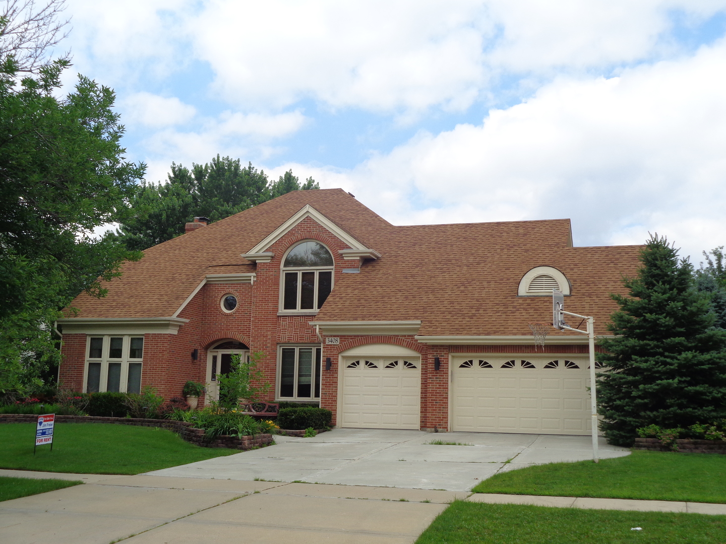 a front view of a house with a garden