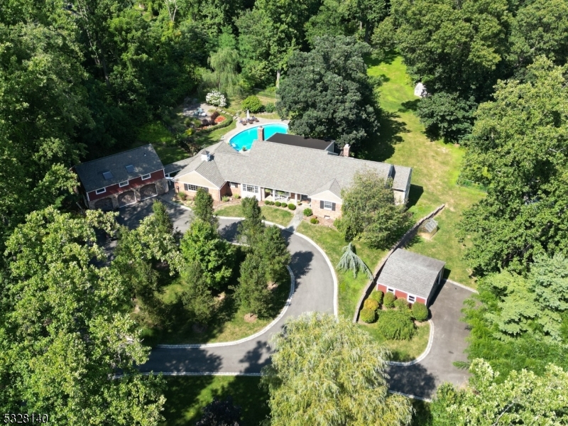 an aerial view of a house with a yard and garden