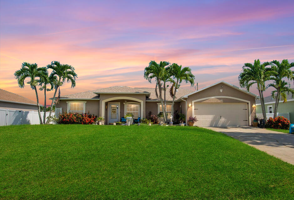 a front view of house with yard and green space