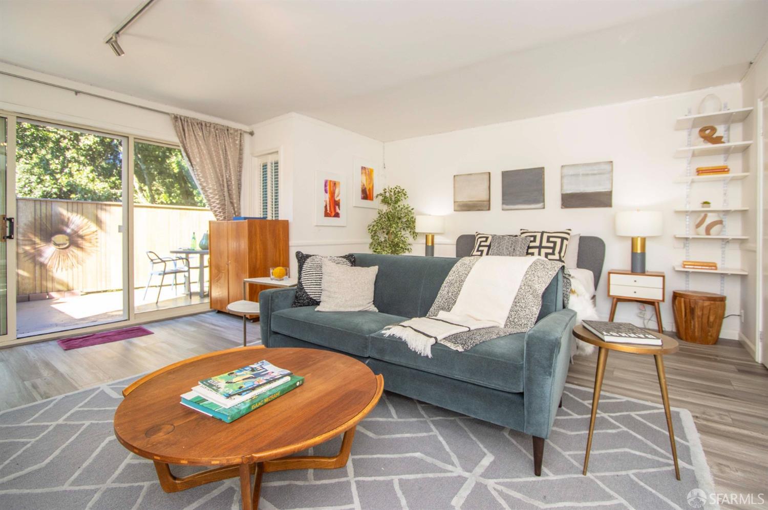 a living room with furniture a rug and a large window