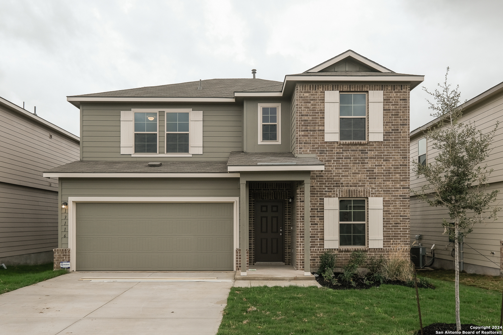 a front view of a house with a yard and garage