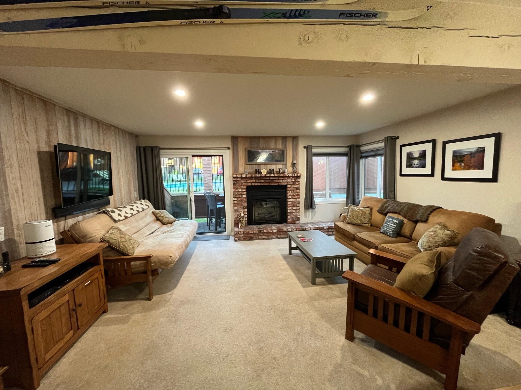 a living room with furniture fireplace and flat screen tv