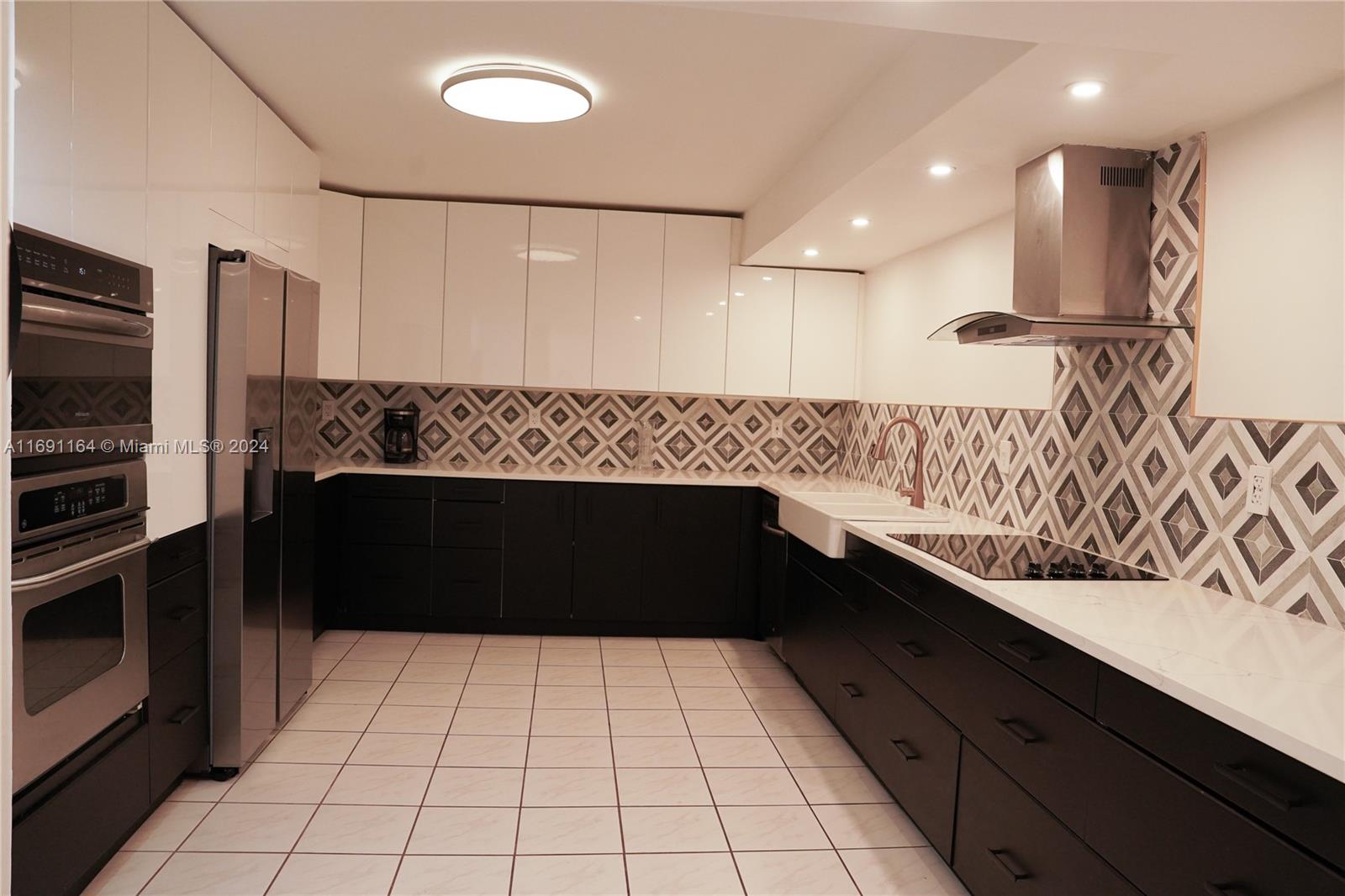 a kitchen with a sink and a stove top oven