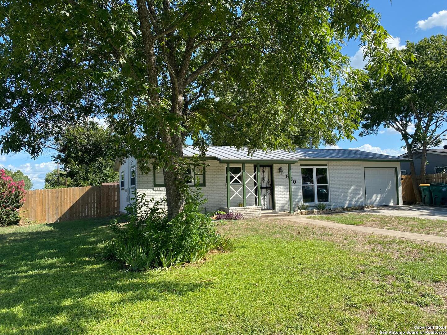 a house view with a sitting space and garden