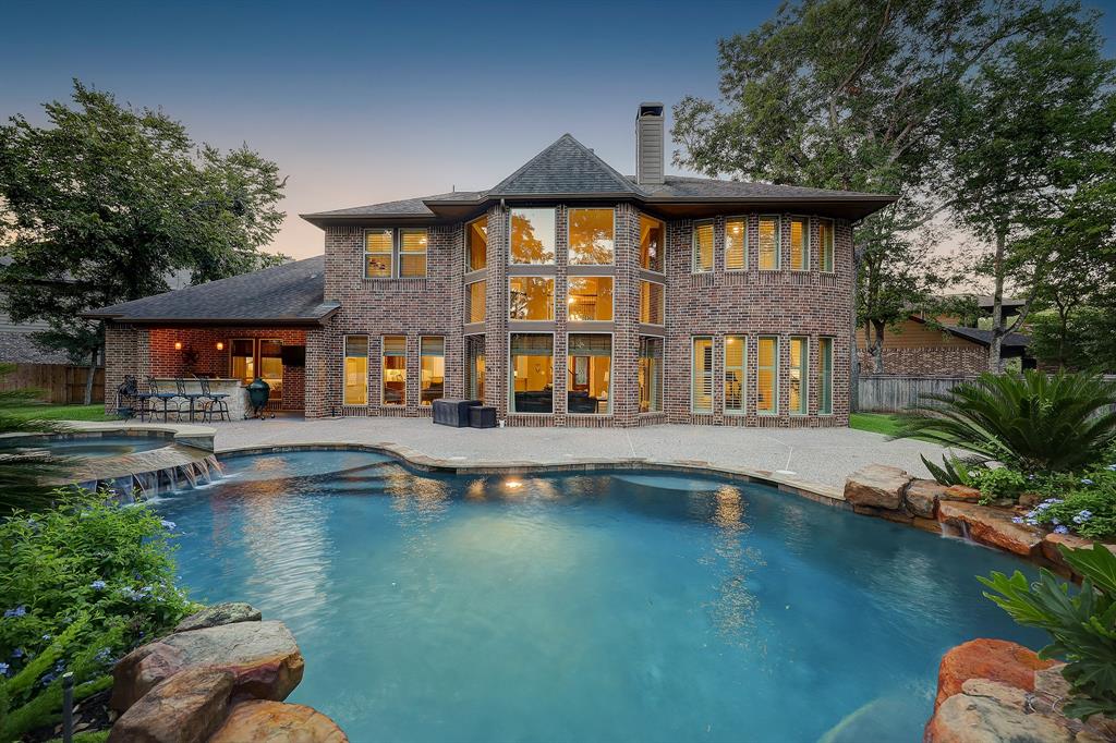 a view of a house with pool and sitting area