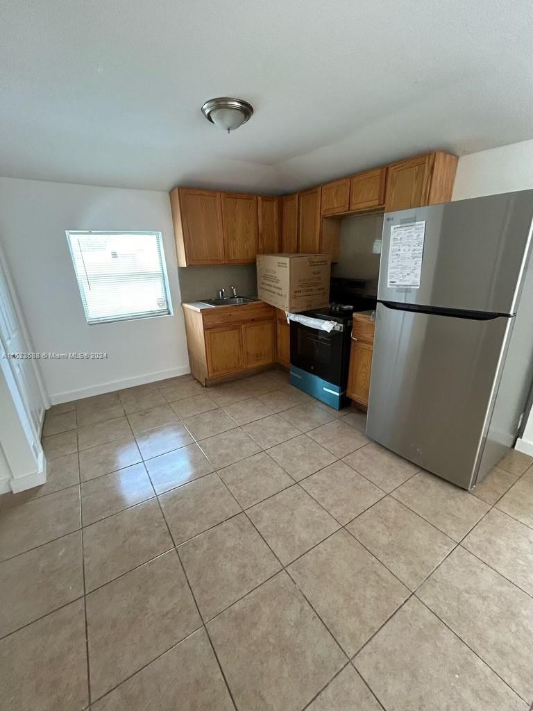 a kitchen with stainless steel appliances a refrigerator and a stove top oven