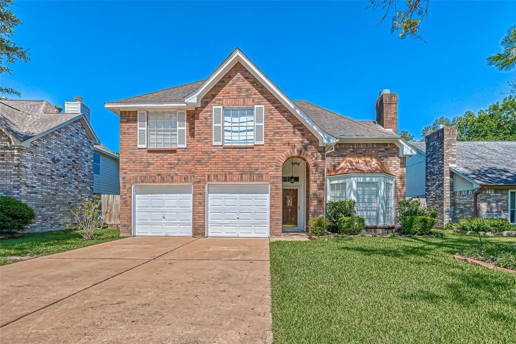 a view of a brick house with a yard