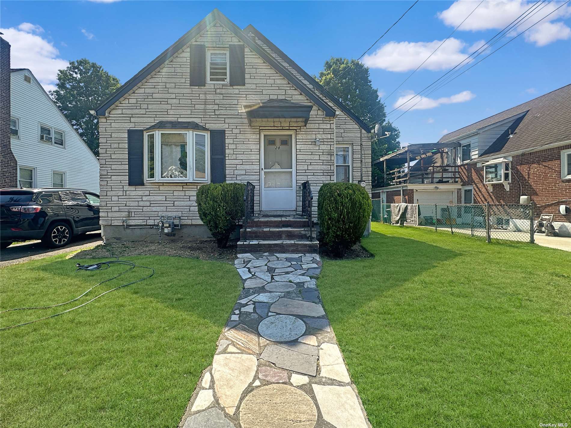 a front view of a house with garden