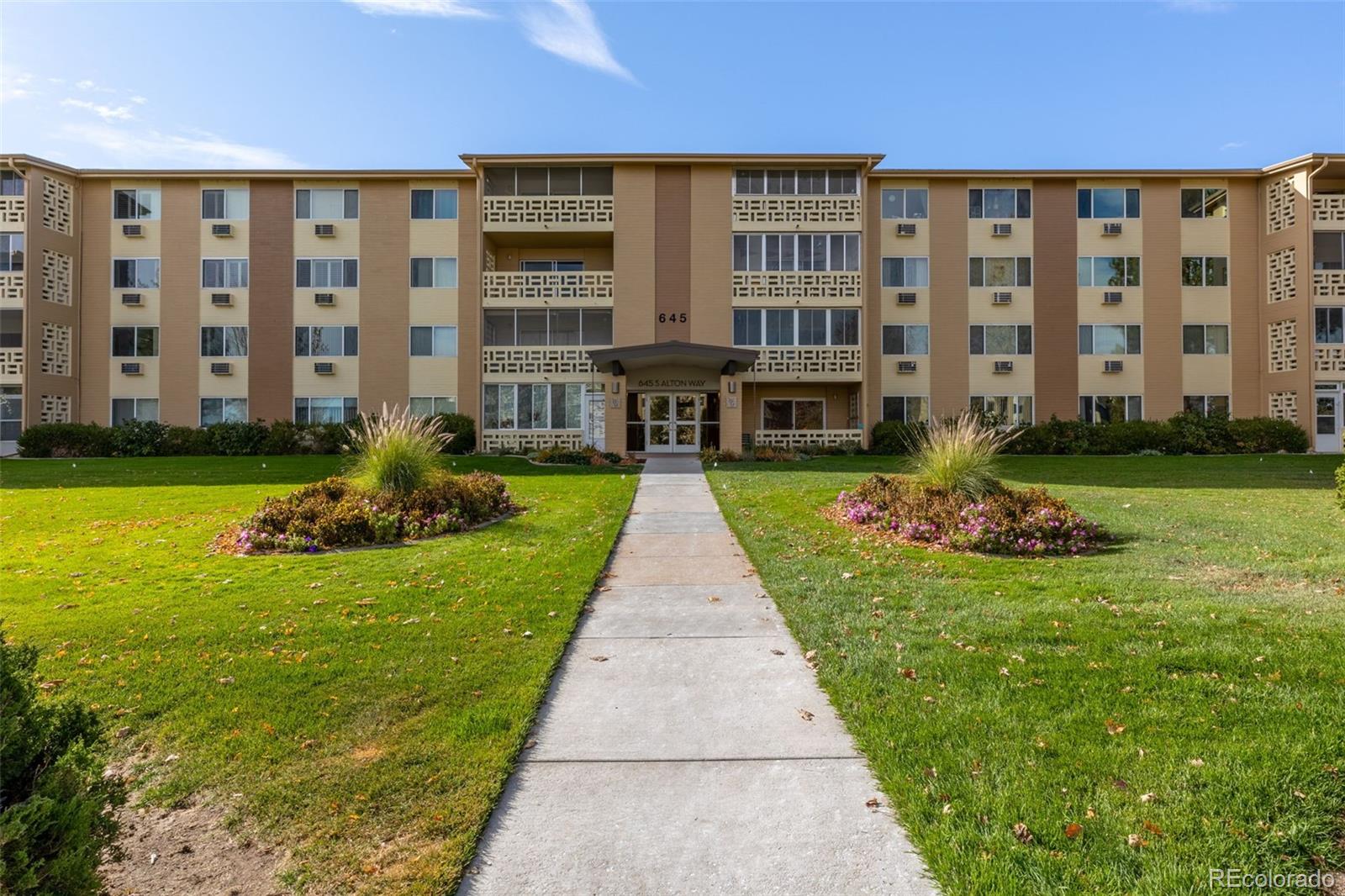 a front view of building with yard and green space