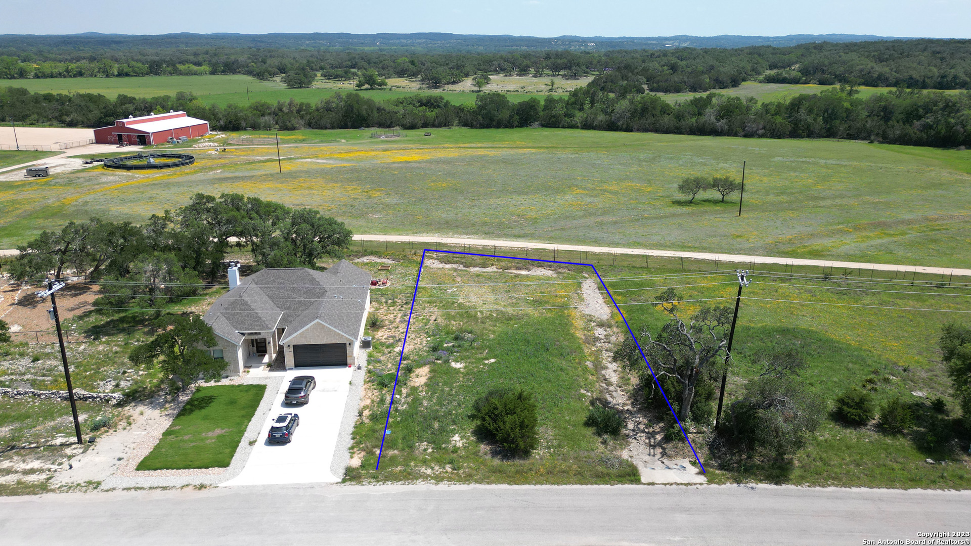 an aerial view of a house with big yard