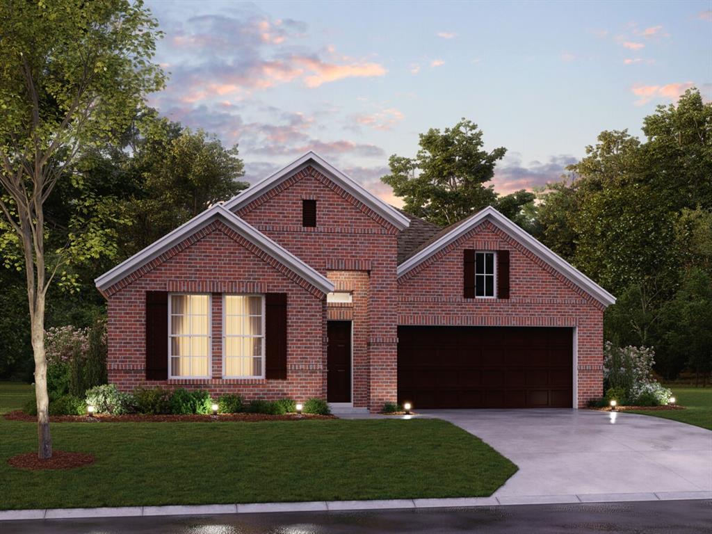 a front view of a house with a garden and yard