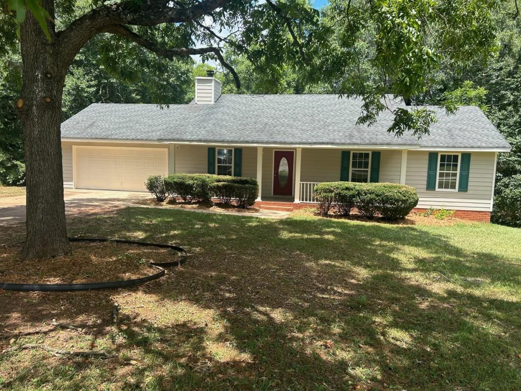 a front view of house with yard outdoor seating and green space