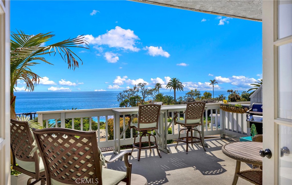 a view of a patio with dining table and chairs