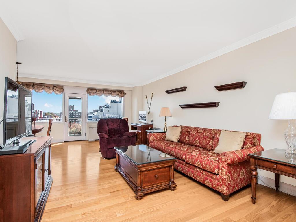 Living room featuring hard wood floors and crown moldings