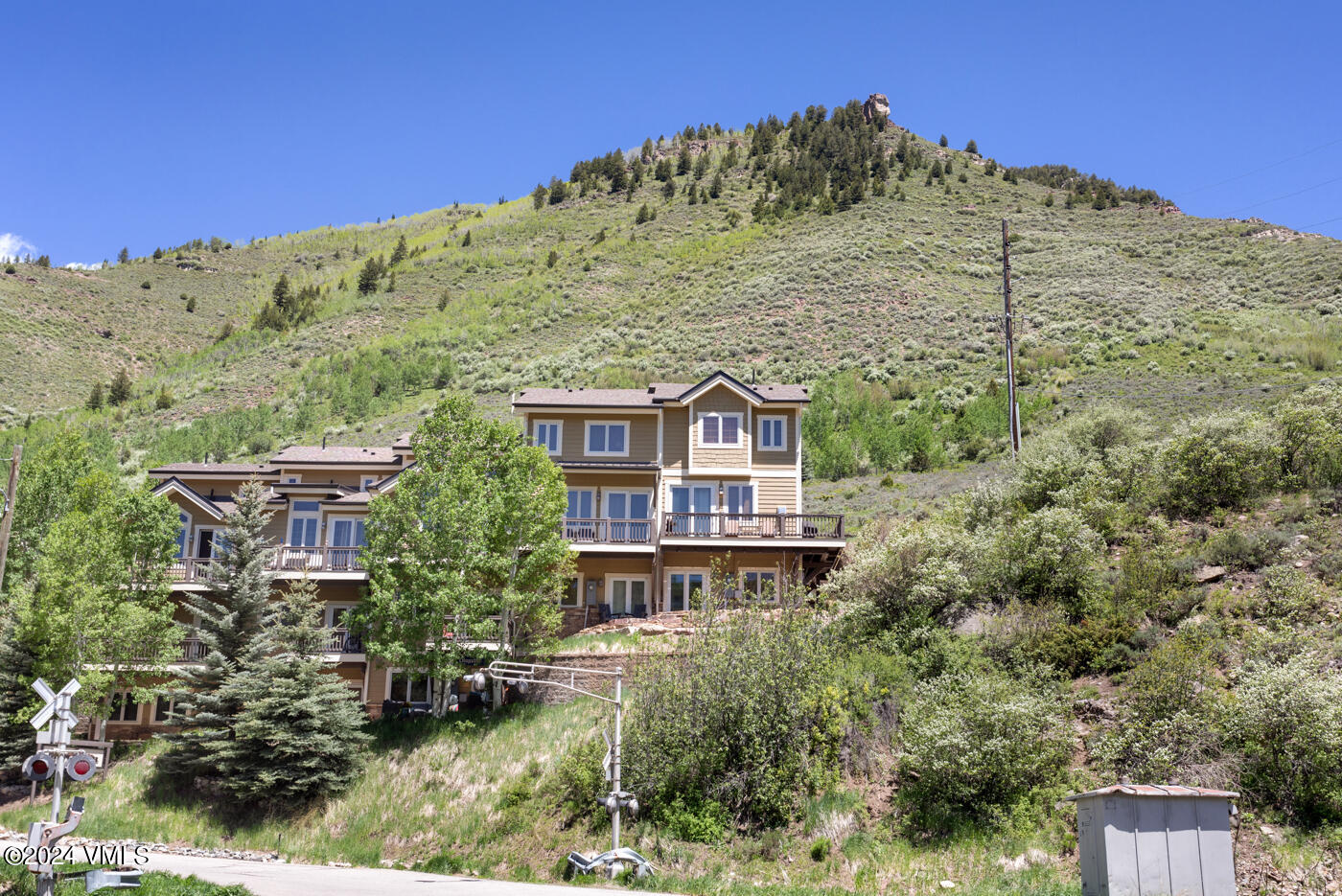 a view of a house with a yard and a wooden fence