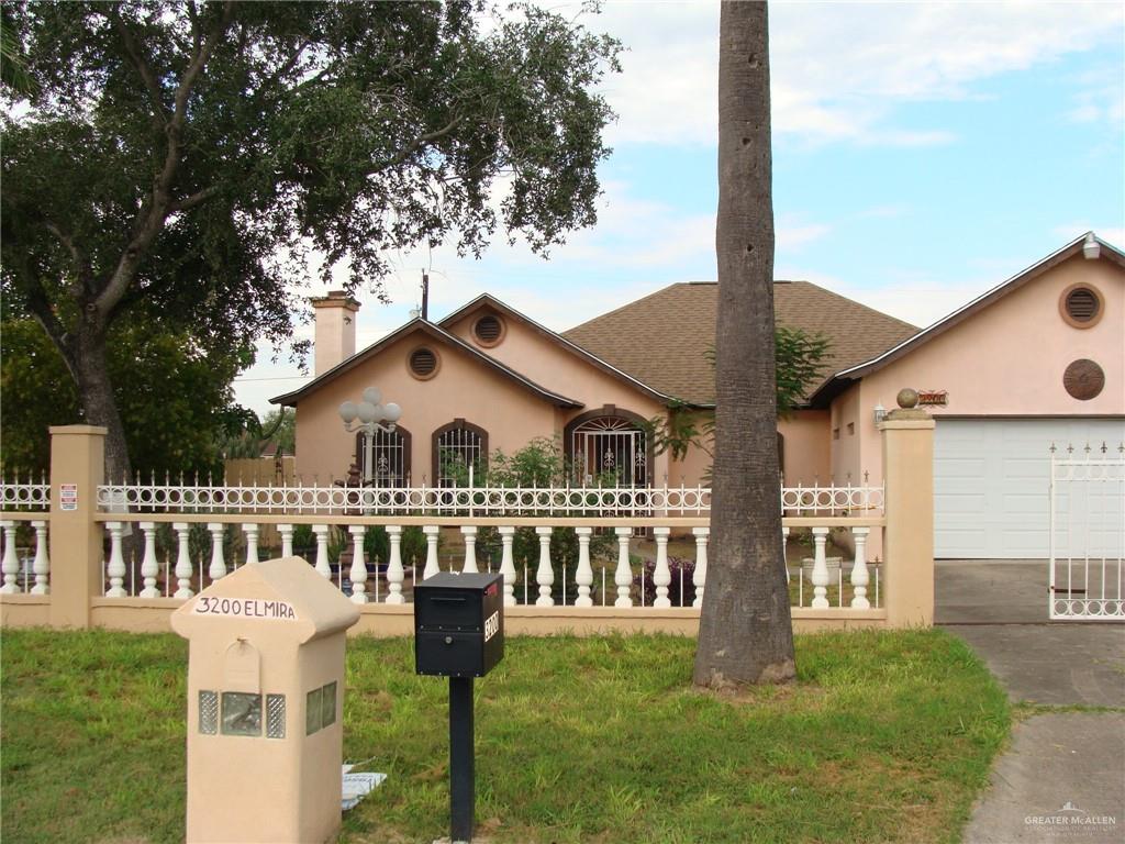 a front view of a house with a garden and yard