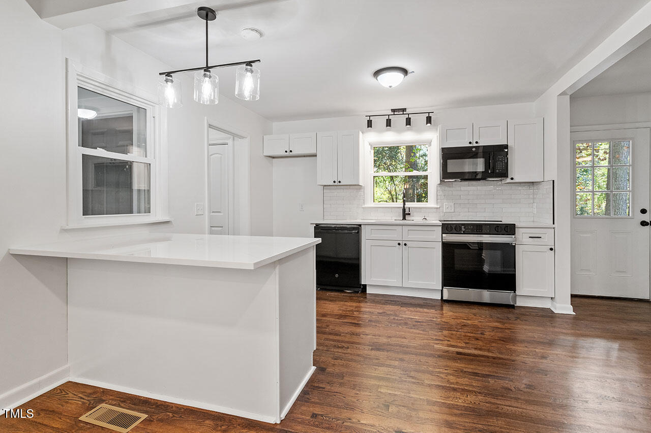 a kitchen with stainless steel appliances a stove top oven and sink