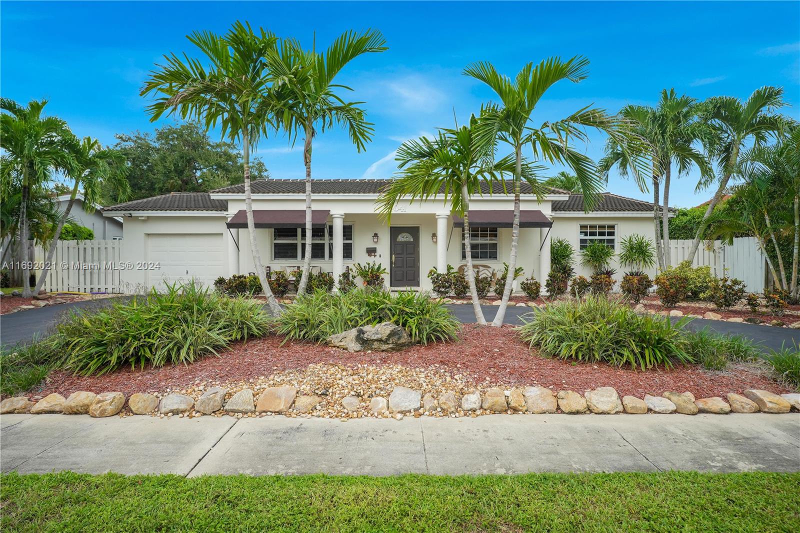 a front view of a house with a garden