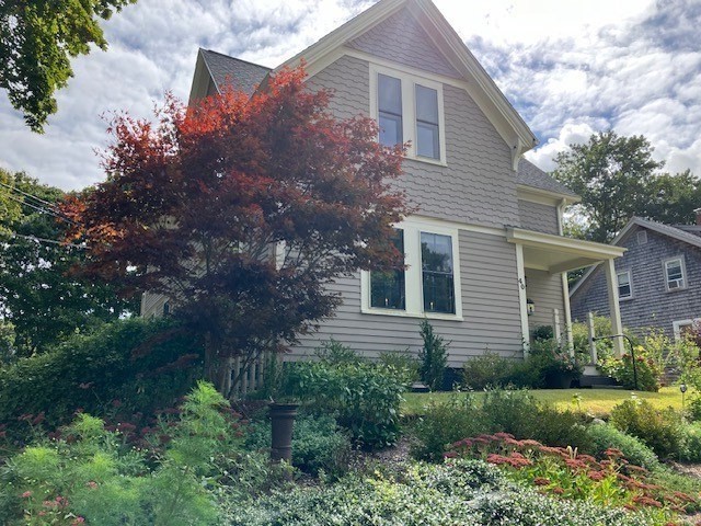 a view of a house with a yard and plants