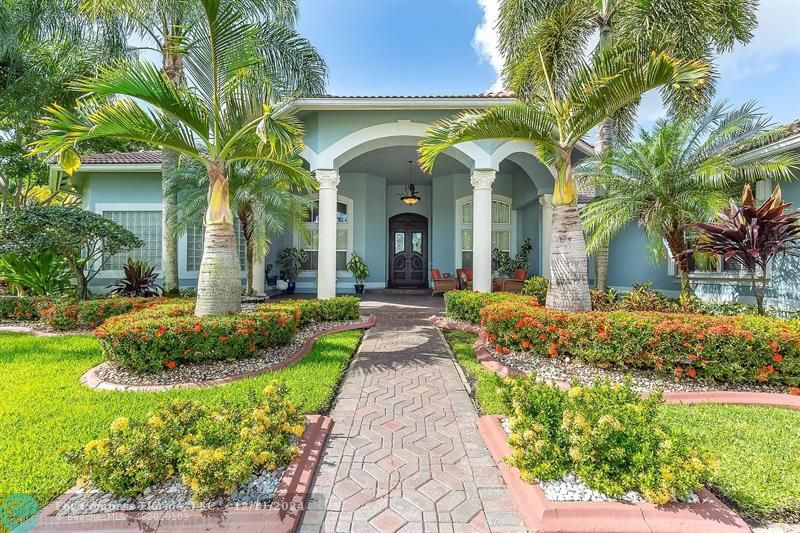 a front view of a house with garden