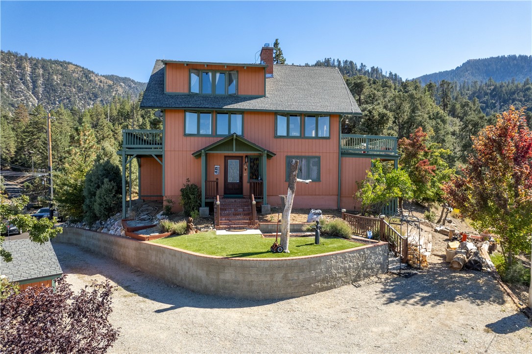 a front view of a house with swimming pool and porch